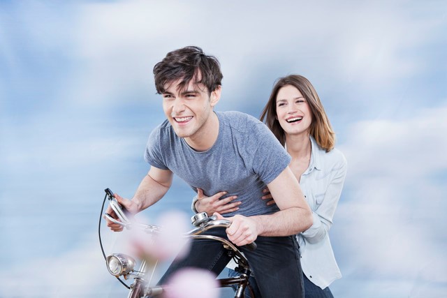 laughing couple on a bicycle