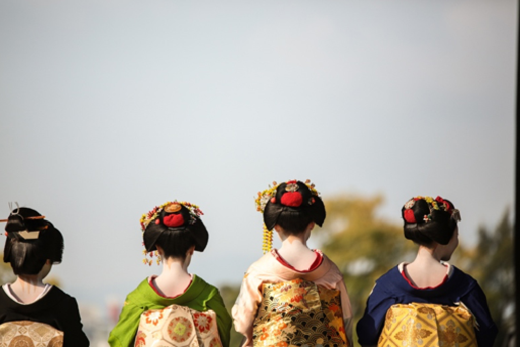 Image shows four geisha's from the back side