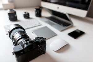 White Desktop Of A Successful Designer With A Laptop With A Mouse With A Modern Professional Camera With A Keyboard With A Laptop With A Graphic Tablet With A Computer. Stylish Workplace.