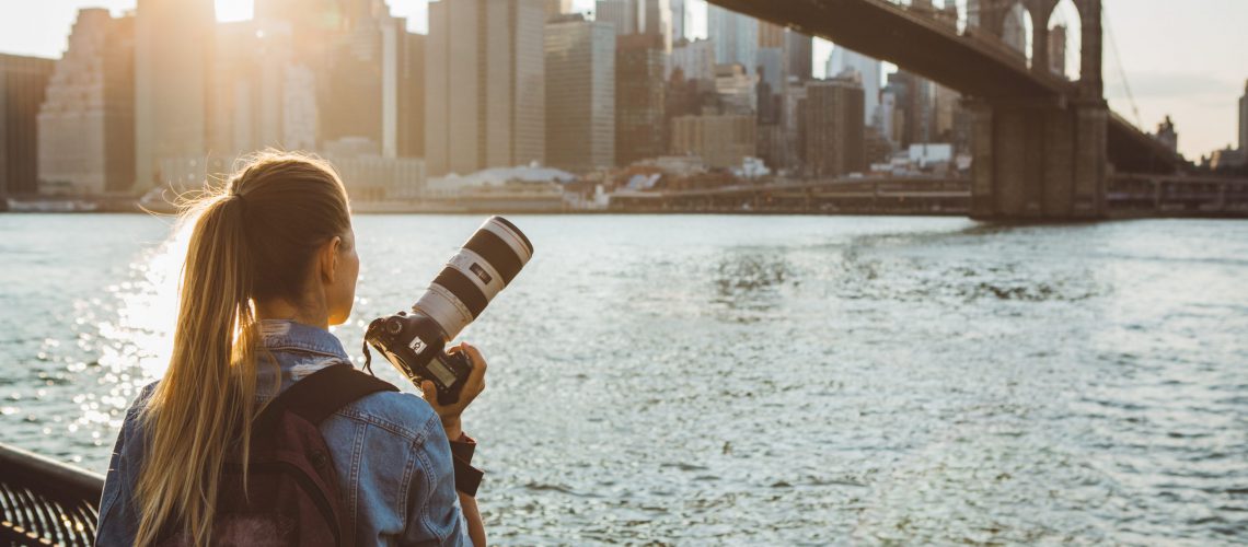 Woman photographer taking picture of Lower Manhattan